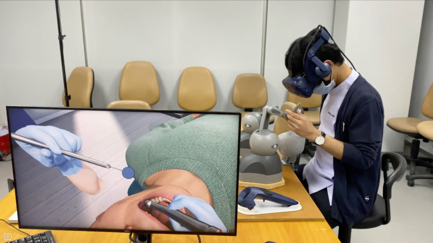 A dental student using the simulator as part of a user study